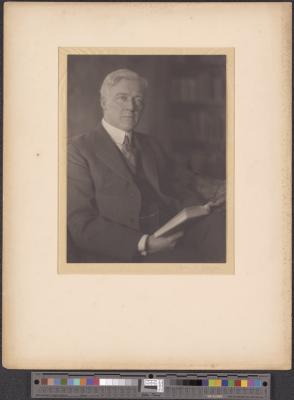 Man in suit, with book [b005] [f010] [002a] (recto)