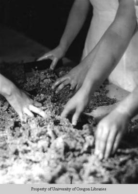 Candy Kitchen, Berea College: hands of women mixing at a table