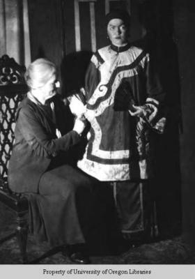Drama student, Berea College: Older women adjusting costume of young woman in yellowface
