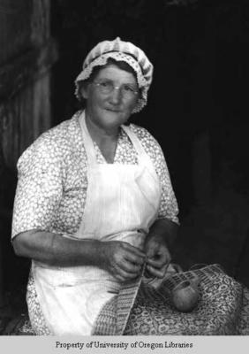 S.U. Wyatt, weaver, dyer, spinner: woman with woven work in lap