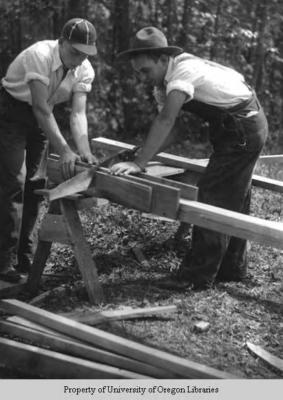Students building a house, Berea College: two men cutting wood for framing