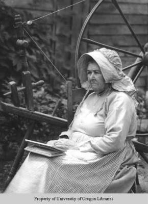 Martha Nichols, spinner and weaver, with wheel