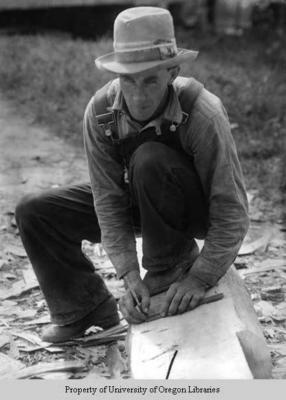 Mr. Stewart, cross-tie maker, working a log