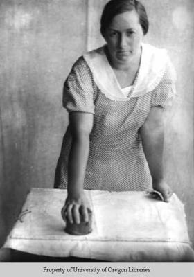 Ethel May Stiles, working with round wooden block