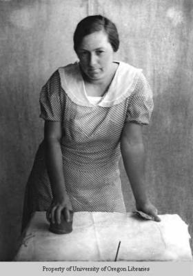 Ethel May Stiles, working with round wooden block