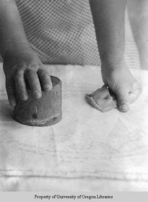 Ethel May Stiles' hands, with round wooden block