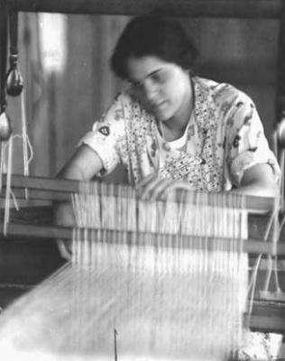 Jane Chase, spinner and weaver, at the loom