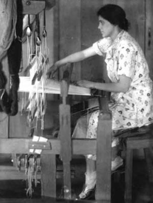 Jane Chase, spinner and weaver, at the loom