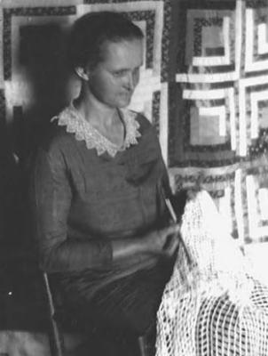 Ms. Ray Burnett, quilter, doing needlework
