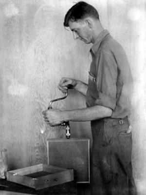 Victor McConkey, carpenter, using brace