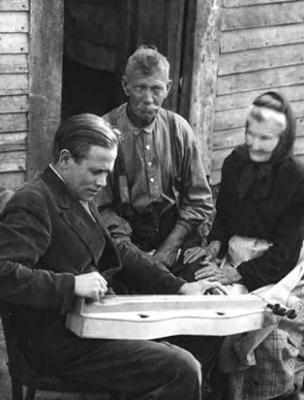 John Jacob Niles with dulcimer, with man and elderly woman