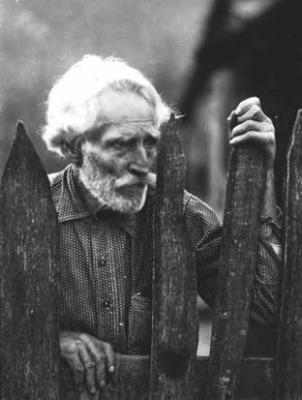 Elderly man [Nick Barton] by picket fence