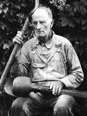 Man, farmer, with posthole digger