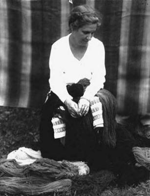 Mrs. Arema Stone Viner, seated with yarn