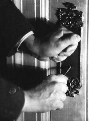Hands of John Jacob Niles, opening a door