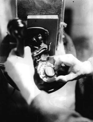 Hands of John Jacob Niles, using a telephone