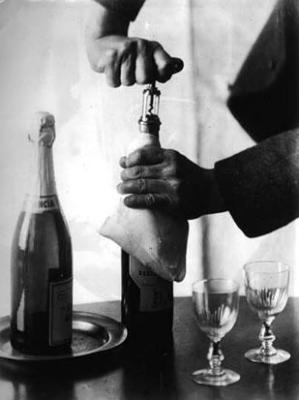 Hands of John Jacob Niles, opening bottle of wine