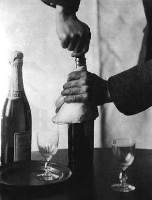 Hands of John Jacob Niles, opening bottle of wine