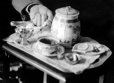 Hands of John Jacob Niles, serving tea