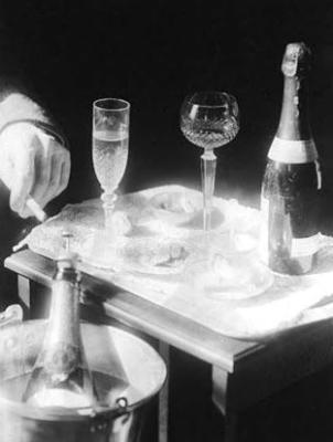 Hands of John Jacob Niles at drinks table