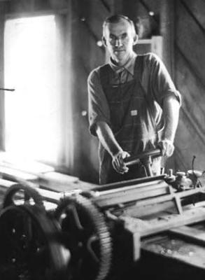Man [working in wood shop?]