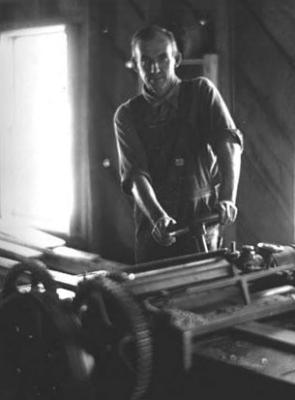 Man [working in wood shop?]